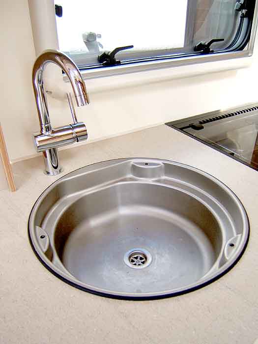 The stainless steel kitchen sink with Swan Neck Mixer Tap.